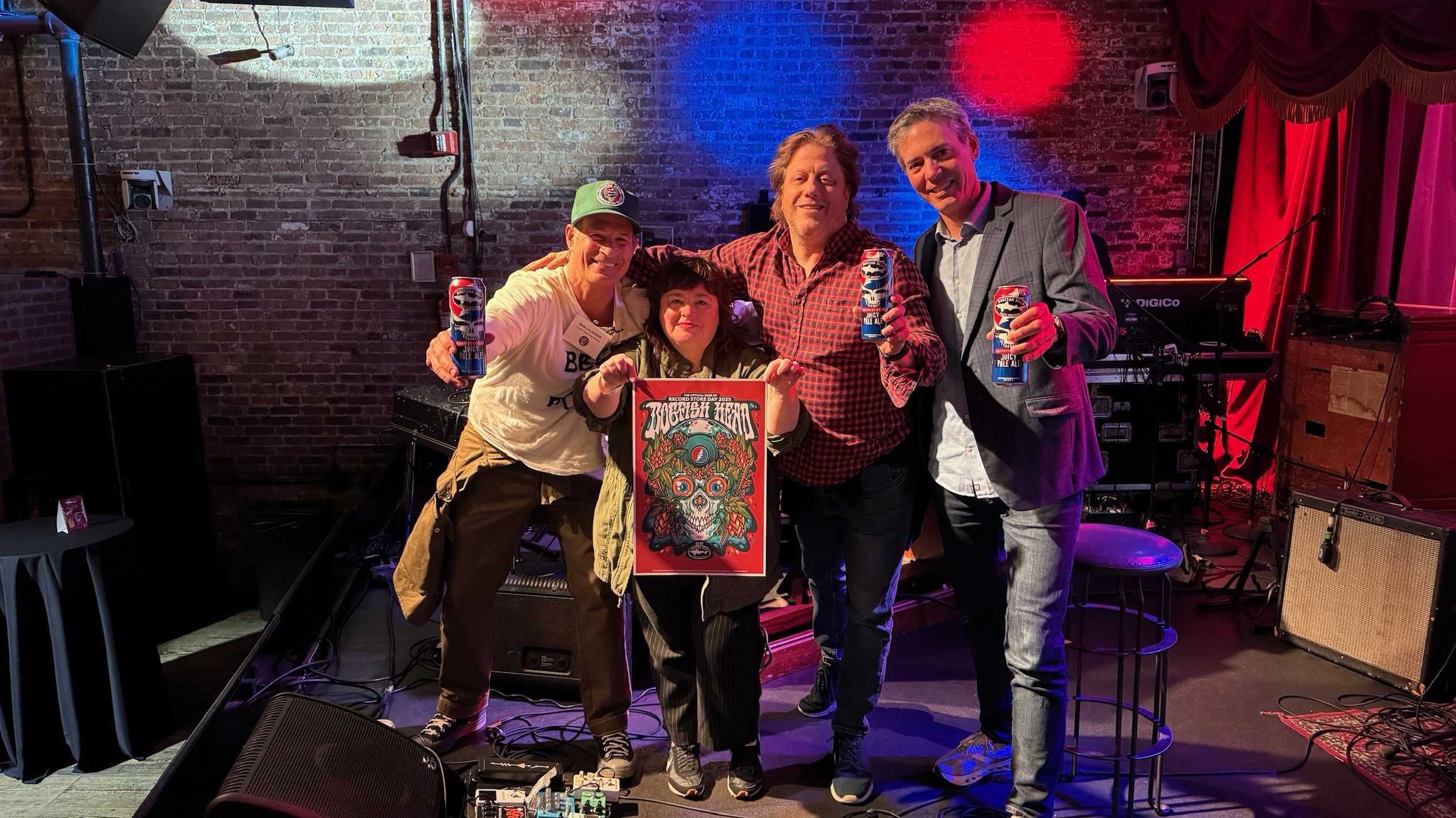 Sam from Dogfish Head, David from the Grateful Dead, Carrie from Record Store Day and Pete from Brooklyn Bowl all standing on a stage holding up the 2025 Record Store Day poster