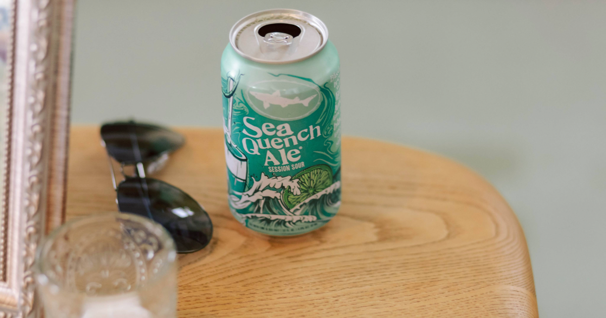 a can of seaquench next to a pair of sunglasses on a table