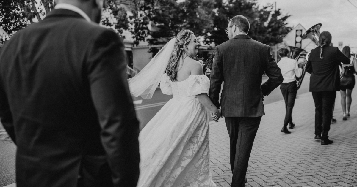 bride and groom walking down street