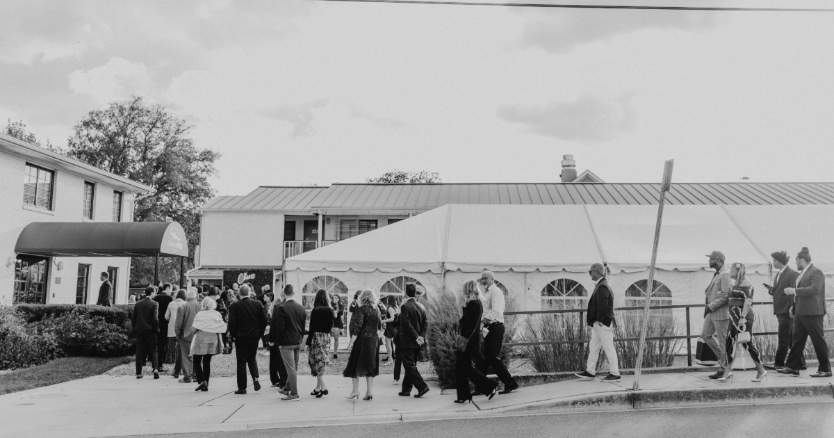 group of wedding guests walking down the street in front of the dogfish inn