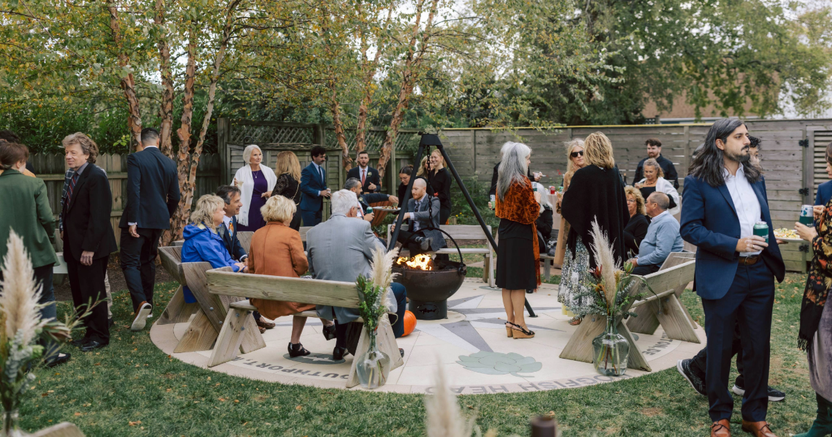 wedding guests around the dogfish inn firepit