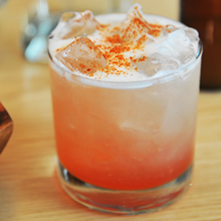 The Daisy cocktail in a glass on a table