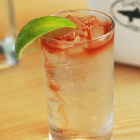 Glass filled with Light & Easy cocktail garnished with a lime slice 