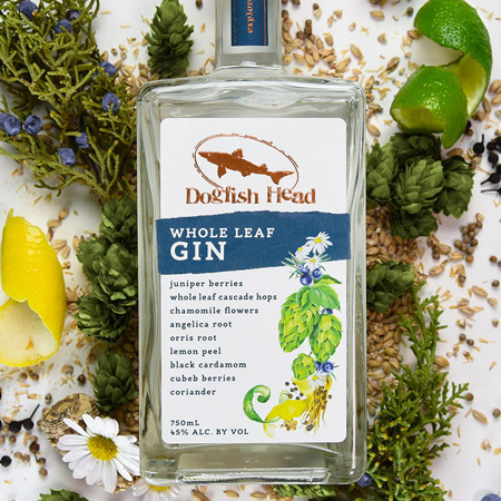 Bottle of Whole Leaf Gin surrounded by ingredients such as lemon and lime peels