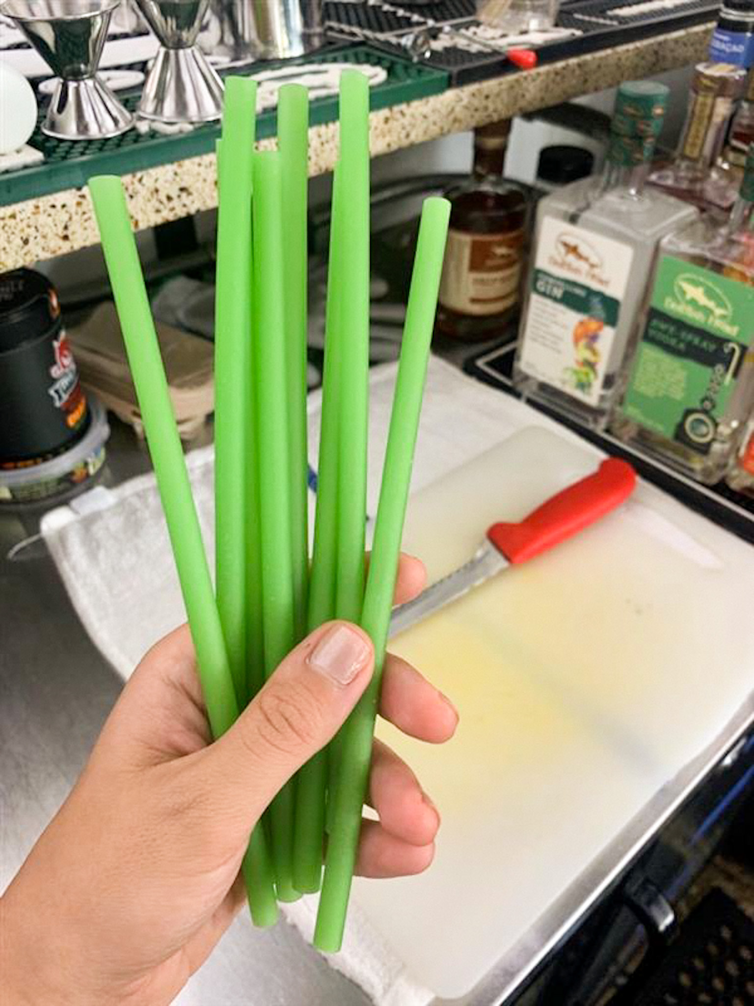 hand holding uncooked pasta used as straws 