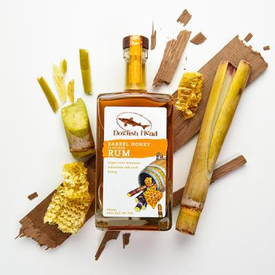 Barrel Honey Rum bottle surrounded by its spirit ingredients