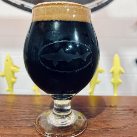 Dark, barrel-aged stout in a glass on a bar