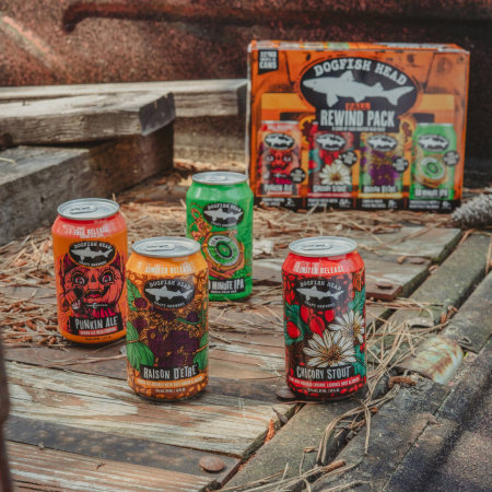 Dogfish Head Fall Rewind Variety Pack witting on a wooden deck with each of the four cans in front of it