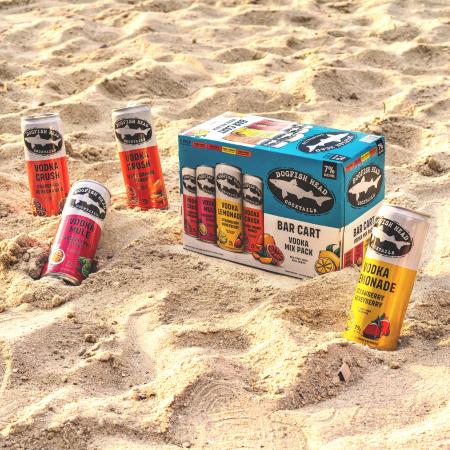 Bar Cart Variety Pack of canned, ready-to-drink cocktails on a sandy beach