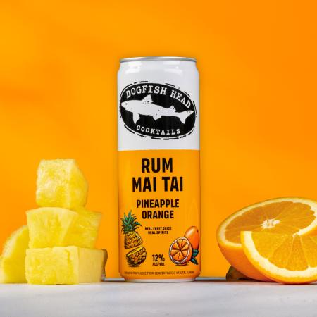 Pineapple and Orange Rum Mai Tai can with real pineapple fruit and oranges sitting next to can