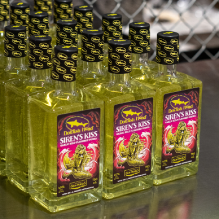 A photo of multiple bottles of green kelp vodka called Siren's Kiss 
