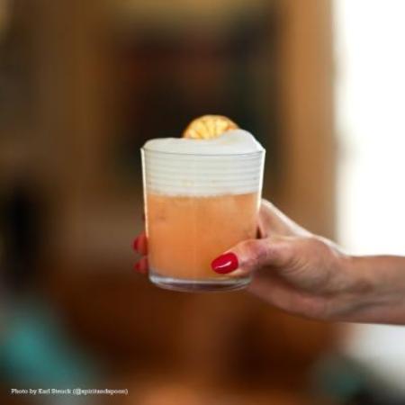 Summer's Cauldron cocktail in hand