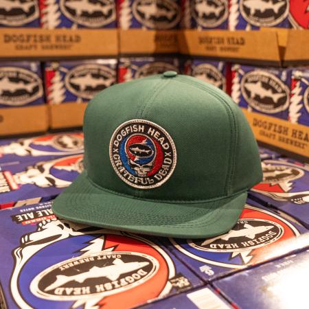 A green colored flat brim hat with the Dogfish Head and Grateful Dead collaboration logo on the front.