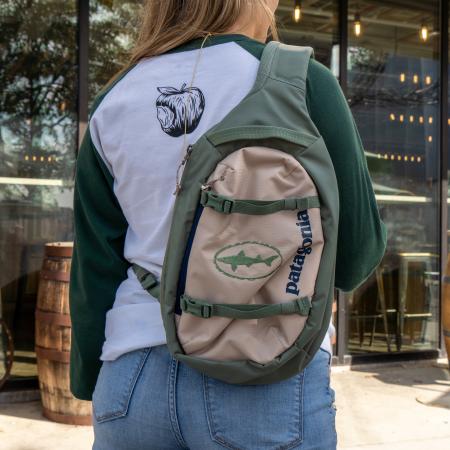 Dogfish Head and Patagonia Green Atom Sling Worn Across Back of Model in Green With Tan Front