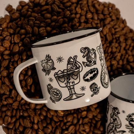 white enamel mug featuring black all over tattoo art 