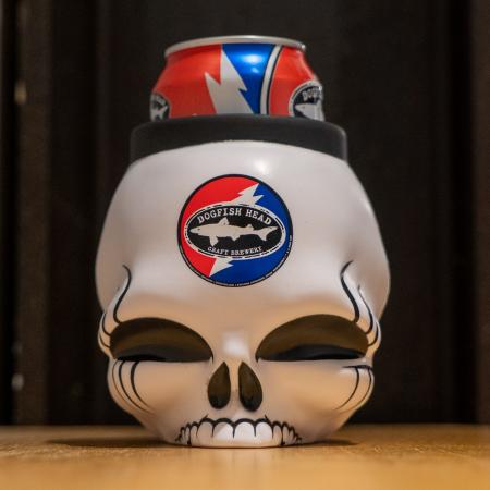 A white skull-shaped can cooler with the Dogfish Head x Grateful Dead design on it.