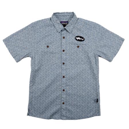 Front view of the patterned Patagonia button-up shirt featuring brown buttons, dual chest pockets, and a black oval Dogfish Head shark patch on the left chest.