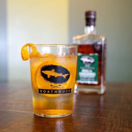 A glass with the Dogfish Head x Boathouse design in black.