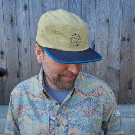 Dogfish Head and Patagonia Brown Maclure Hat in Khaki with Blue Brim on Model Outside