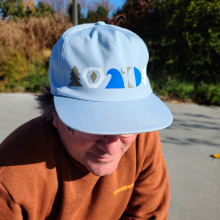 Dogfish Head and Patagonia Blue Funfarer Hat in Ice Blue Color with Grey Blue and White Symbols Across The Front Worn by Model