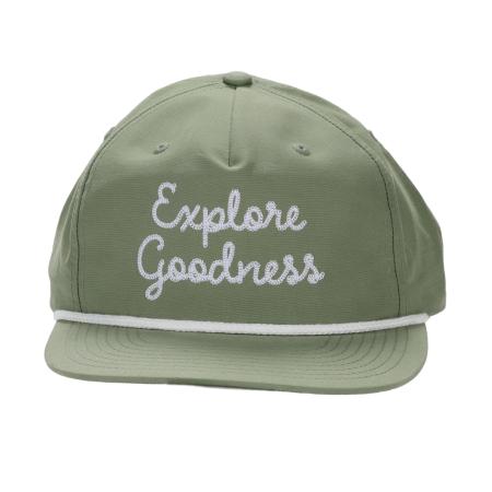 Front view of a sage green Richardson snapback hat with "Explore Goodness" embroidered in white script across the crown and a white rope detail along the brim.