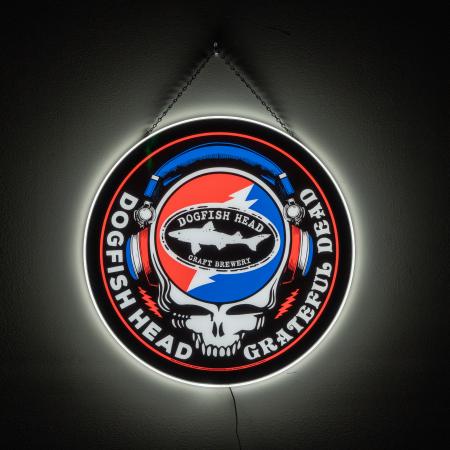 An LED sign of the Dogfish Head and Grateful Dead collaboration logo, hung up on a wall with a black chain.
