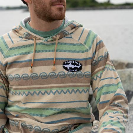 Male model wearing Howler multi stripe terry cloth stripe hoodie with small Dogfish Head shark & shield embroidered logo on left chest area. 