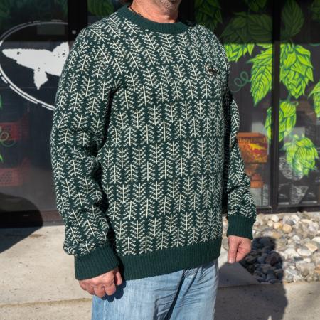Dogfish Head and Patagonia Pine Green Pattern Wool Sweater in Green With White Pine Tree Pattern and Black Dogfish Head Shark Logo On Front Worn By a Model
