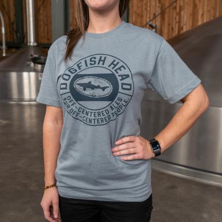 Dogfish Head Grey Camp OCA Tee in Grey with Dark Blue Off-Centered Ales Camp Logo On The Front with Strong Model