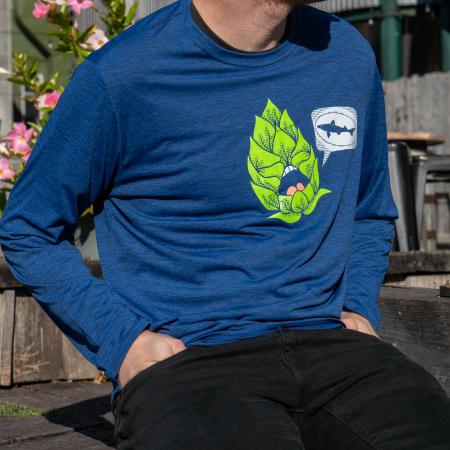 Dogfish Head Long Sleeve Viking Blue Shirt with Light Green Hop Graphic and White Dogfish Head Shark Logo on The Front Worn By a Model