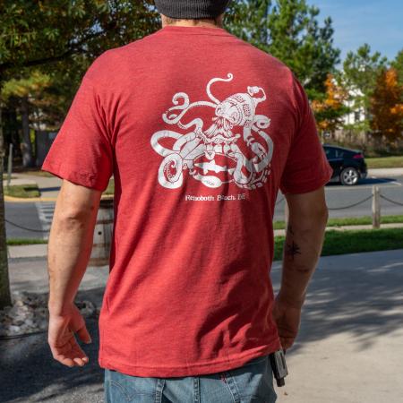 Red Kraken Tee in Red with White Kraken Graphic on The Back Worn by a Model