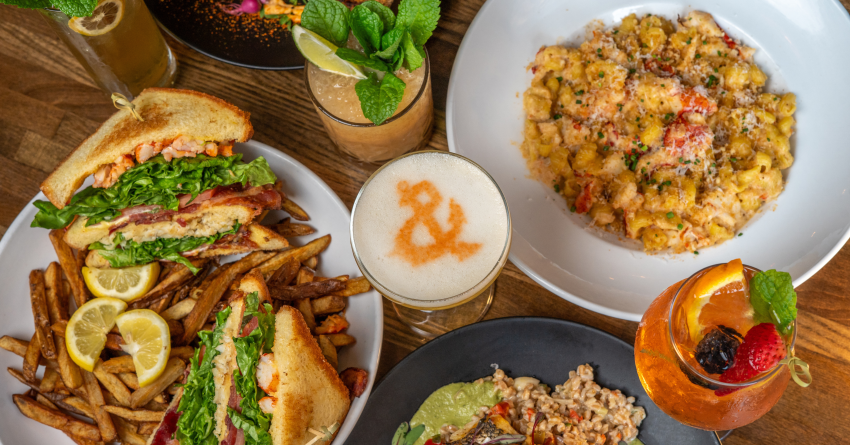photo of a variety of dishes and cocktails on a table at Dogfish Head Chesapeake & Maine