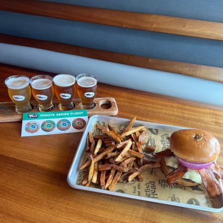 A photo of a burger and minute series flight at Dogfish Head Brewings & Eats