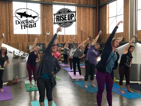 Yoga in the brewhouse with beer cans in hand