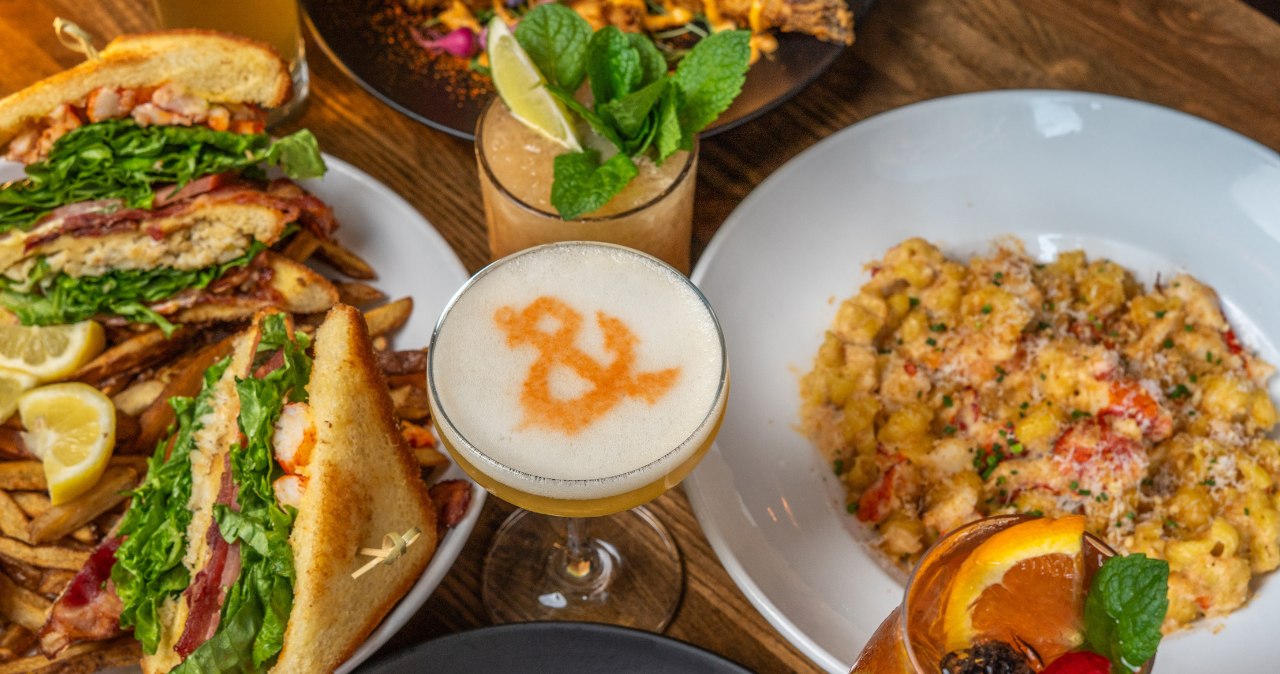 photo of a table with a bunch of food and cocktails