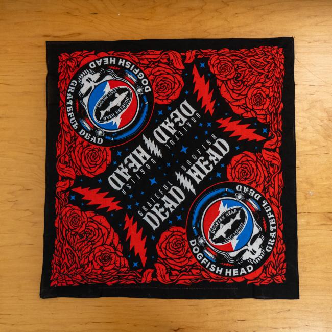 Flat lay image of bandana featuring roses, Dogfish x Grateful Dead skull logo and Dead Head text. 