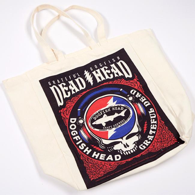 Front image of Dogfish Head x Grateful Dead tote bag. Large graphic with Grateful Dogfish Dead Head logo at top with red blue skull shark and shield art work. 