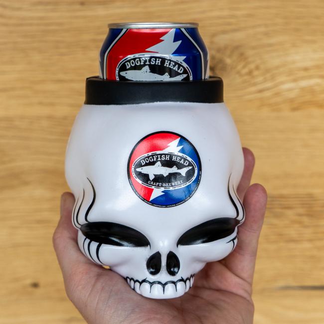 A white skull-shaped can cooler with the Dogfish Head x Grateful Dead design on it.