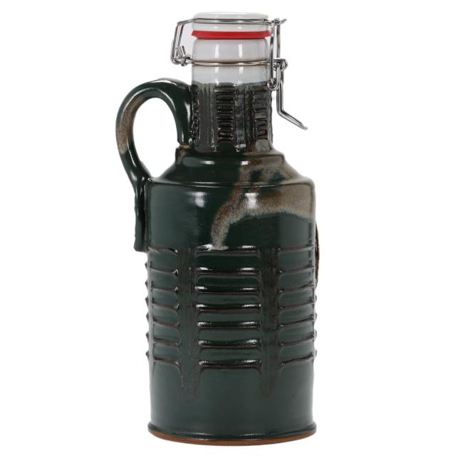 Back view of the ceramic growler showing textured detailing and the continuation of the dark green glaze with natural brown highlights.