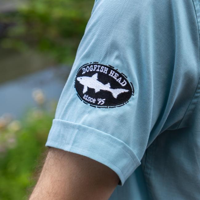 Close up of Dogfish Head embroidered shark & sheild logo with since 95 text