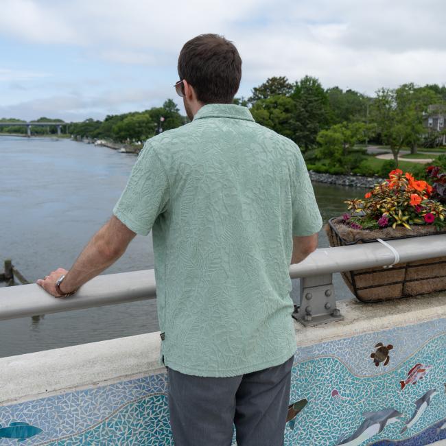 Back shot of male model wearing Howler short sleeve textured terry polo.