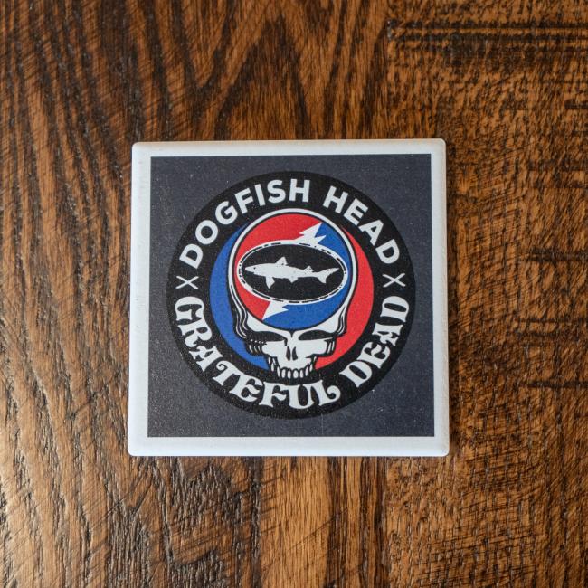 Square ceramic coaster overhead image featuring Dogfish x Grateful Dead collaboration artwork with skull, shark and shield,