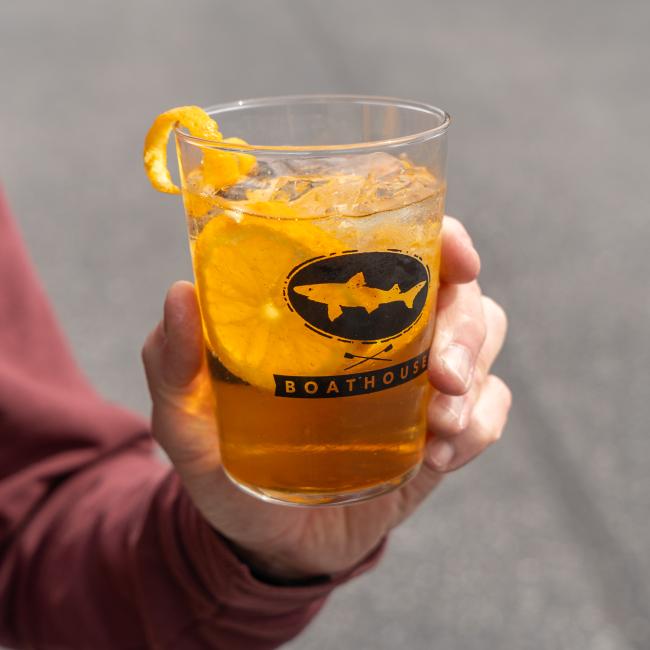 A glass with the Dogfish Head x Boathouse design in black.