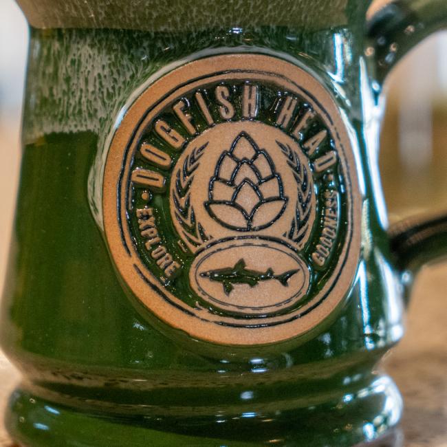 Dogfish Head Explore Goodness Mug Featuring an Up Closed Detailed View of Our Green Stoneware Mug with Imprinted Hops Design