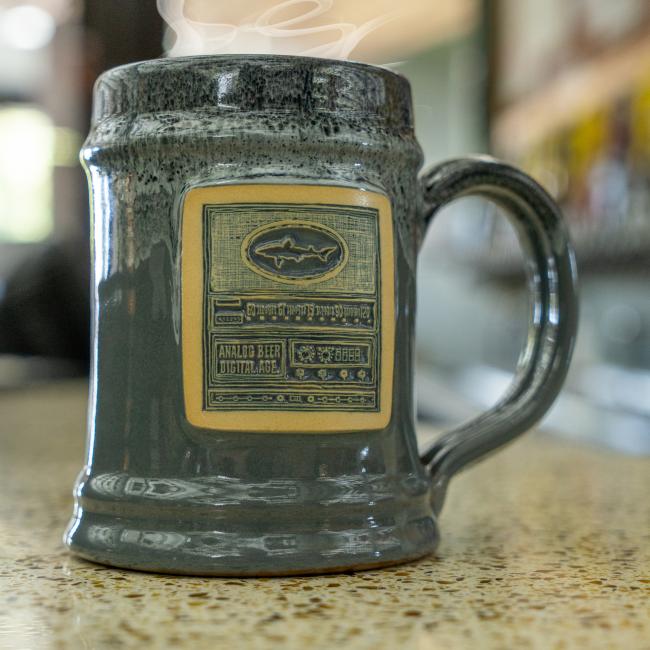 Dogfish Head Grey Analog Ceramic Mug With Analog Image Carved Into The Front Full Image of Mug on Counter