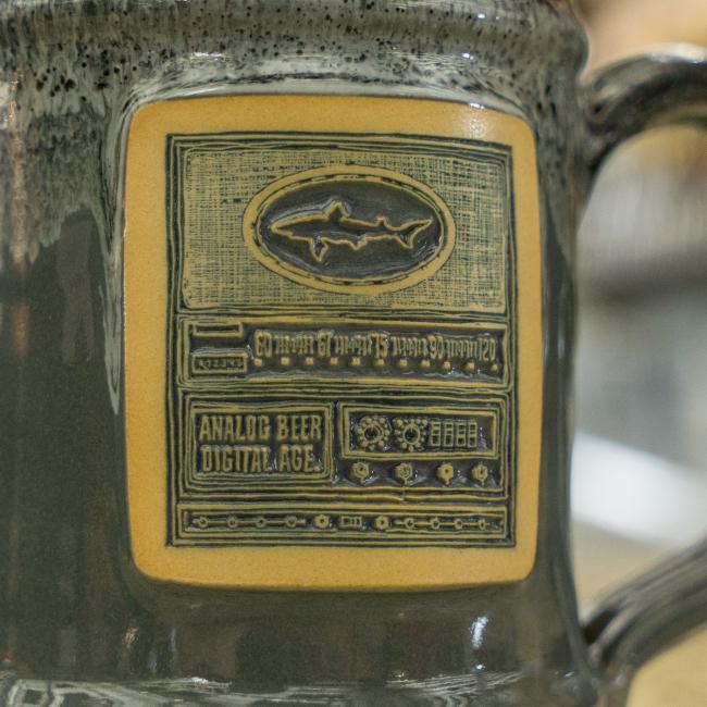 Dogfish Head Grey Analog Ceramic Mug With Analog Image Carved Into The Front Up Close Image of The Front of The Mug