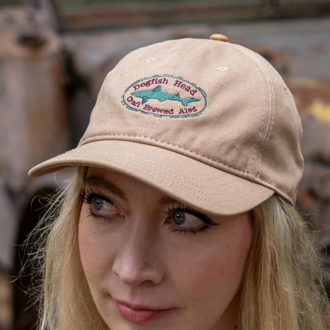 Close-up of the front of the tan Dogfish Head hat, featuring the embroidered