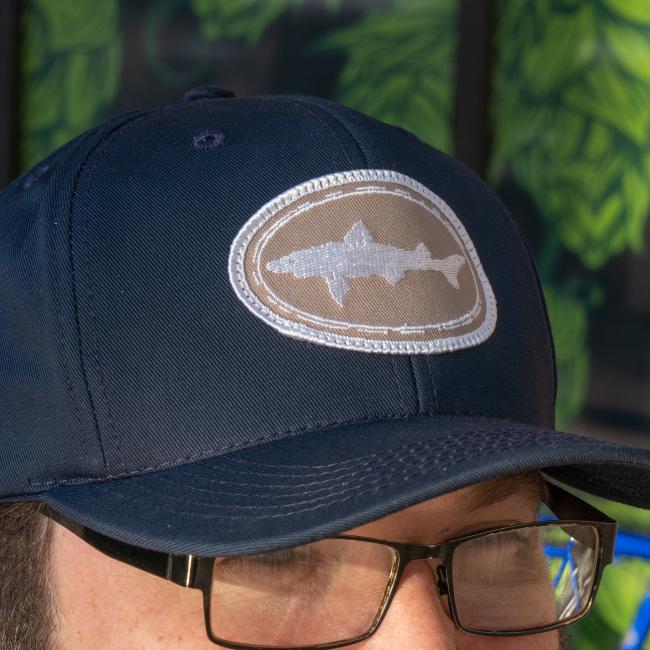 Dogfish Head Navy Twill Flat Snap Back Hat in Navy with Tan Dogfish Head Logo Patch on Front