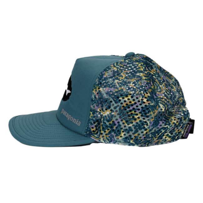 Left side view of the Patagonia trucker hat showing multicolor mesh side panels with an abstract pattern in teal, yellow, purple, and black, along with the embroidered front logo and text.