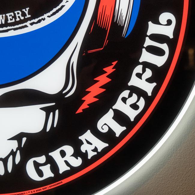 Close up view of the bottom right side of the LED sign of the Dogfish Head and Grateful Dead collaboration logo.